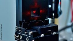 Image: The image shows a spatial light modulator setup projecting a red laser pattern in the shape of a butterfly; Copyright: Fraunhofer ILT, Aachen, Germany. 
