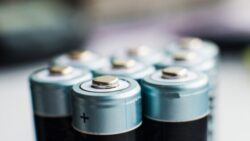 Image: A couple of batteries are in the foreground with a blurred background.